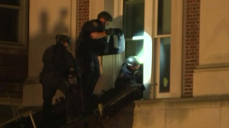 Police enter occupied university building through the window