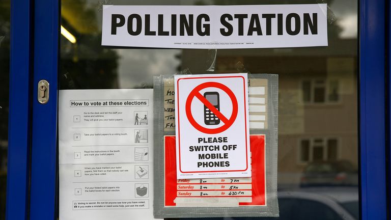 A sign telling voters to switch off their phones on the door of a polling station. Pic: Reuters