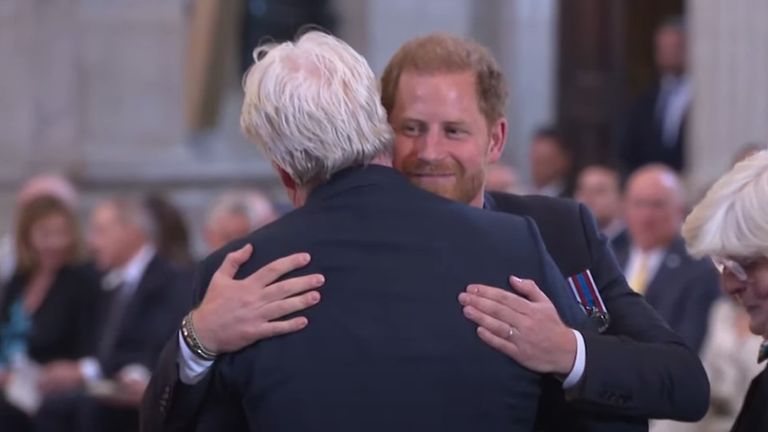 Prince Harry is hugged during hte Invictus Games Foundation 10th Anniversary Service of Thanksgiving.
