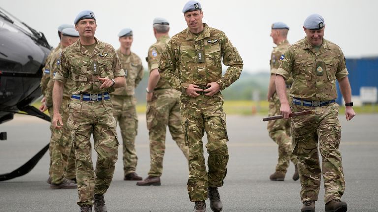 The Prince of Wales (centre) walks with service personnel at the Army Aviation Centre in Middle Wallop, Hampshire, after King Charles III officially handed over the role of Colonel-in-Chief of the Army Air Corps to the Prince of Wales. Picture date: Monday May 13, 2024.