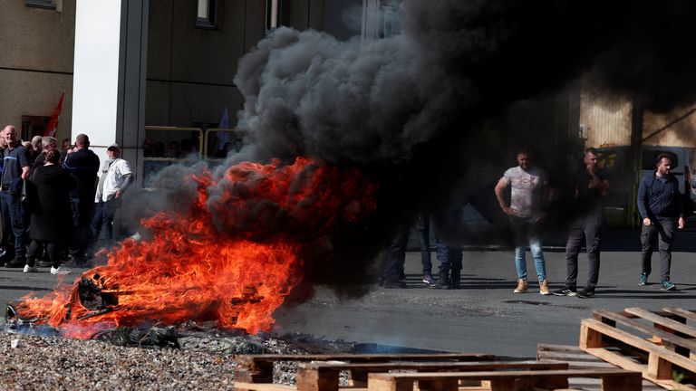 A fire burns as prison staff block the entrance of a detention centre  in Val De Reuil, France. Pic: Reuters