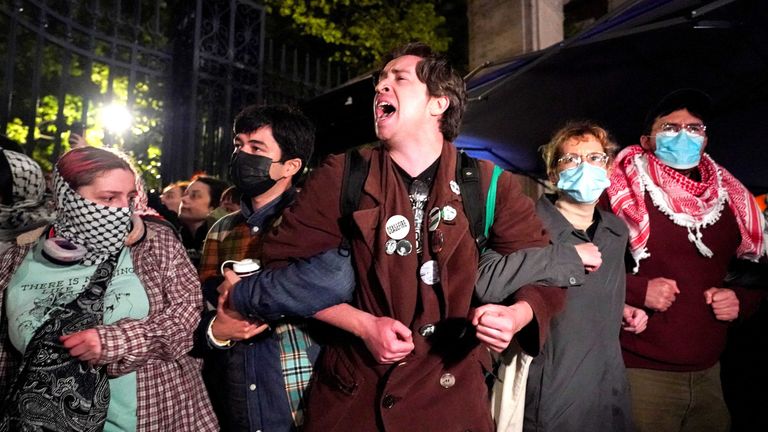 Protestors link arms as other police officers enter the campus of Columbia University.
Pic: Reuters