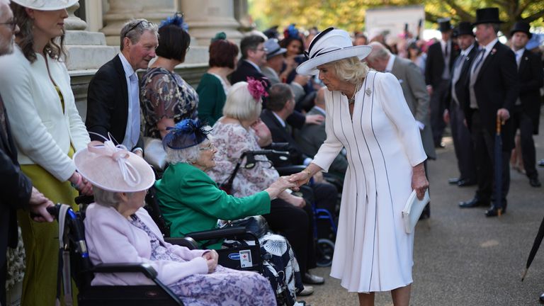 Queen Camilla speaks to guests.
Pic: PA