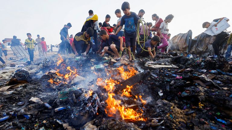 Pic: Reuters
Palestinians search for food among burnt debris in the aftermath of an Israeli strike on an area designated for displaced people, in Rafah in the southern Gaza Strip, May 27, 2024. REUTERS/Mohammed Salem