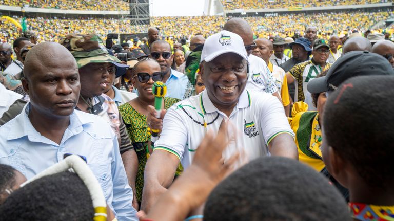South African President Cyril Ramaphosa, wearing a cap, arrives at a stadium in Durban for his party's manifesto launch. Pic: AP