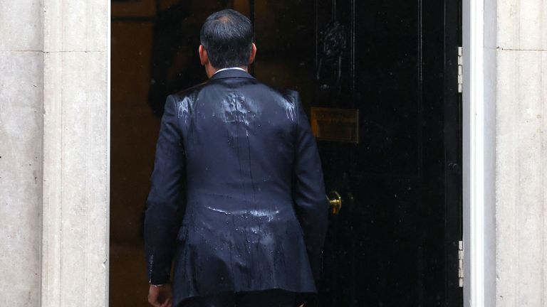 Rishi Sunak enters Number 10 Downing Street after delivering a speech.
Pic: Reuters