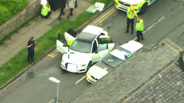 Officers at the scene after the high-speed chase. Pic: Greater Manchester Police