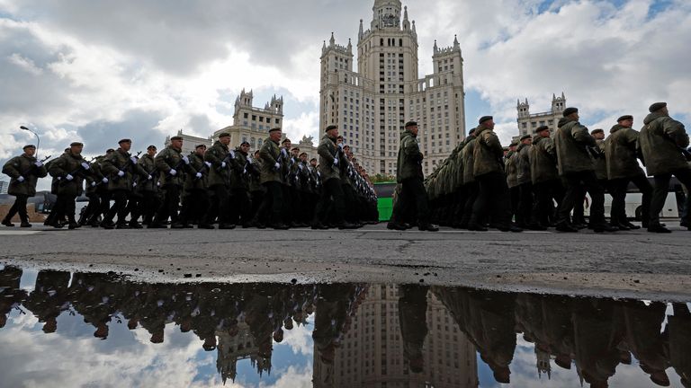 Russian service members march in columns just before the parade. Pic: Reuters