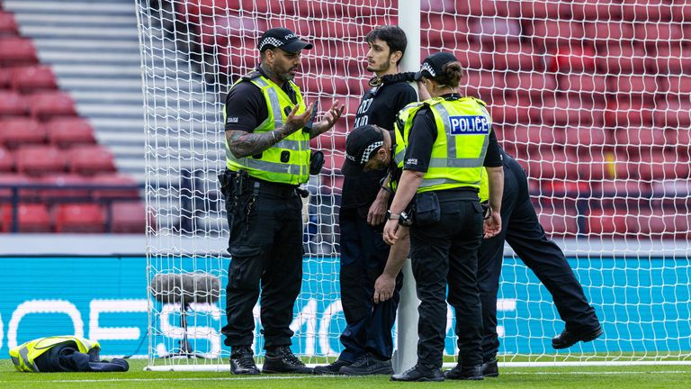 A protester locks himself to a goal post in protest against Israel during a UEFA European Championship tie between Scotland and Israel at Hampden Park on May 31, 2024. Photo: Grupo SNS