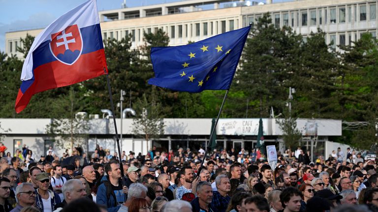Protesters hold Slovak and European Union flags as demonstrators take part in a protest against government changes at public broadcaster RTVS in Bratislava, Slovakia, May 2, 2024. REUTERS/Radovan Stoklasa
