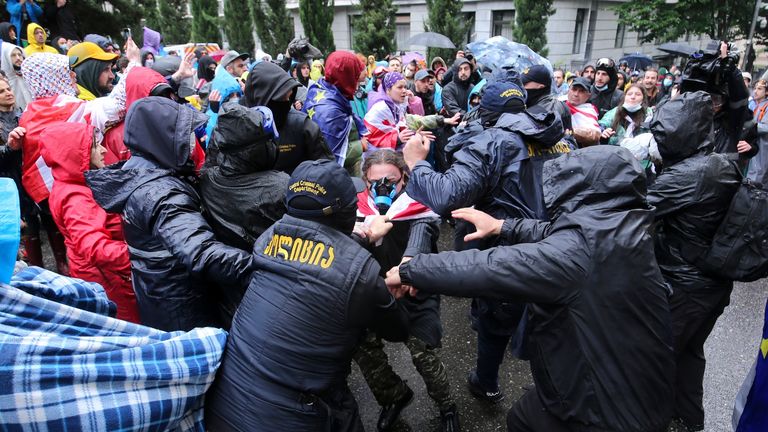 Police try to detain demonstrators near the Parliament building during an opposition protest against "the Russian law" in the center of Tbilisi, Georgia, on Monday, May 13, 2024. Daily protests are continuing against a proposed bill that critics say would stifle media freedom and obstruct the country&#39;s bid to join the European Union. (AP Photo/Zurab Tsertsvadze)