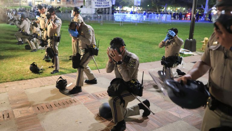 CHP officers put on their gear amid clashes near an encampment on UCLA.
Pic: Reuters