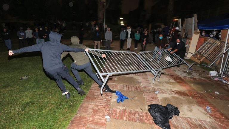 Counter-protesters try to remove barricades at a pro-Palestinian encampment on the University of California, Los Angeles (UCLA) campus. Pic: Reuters