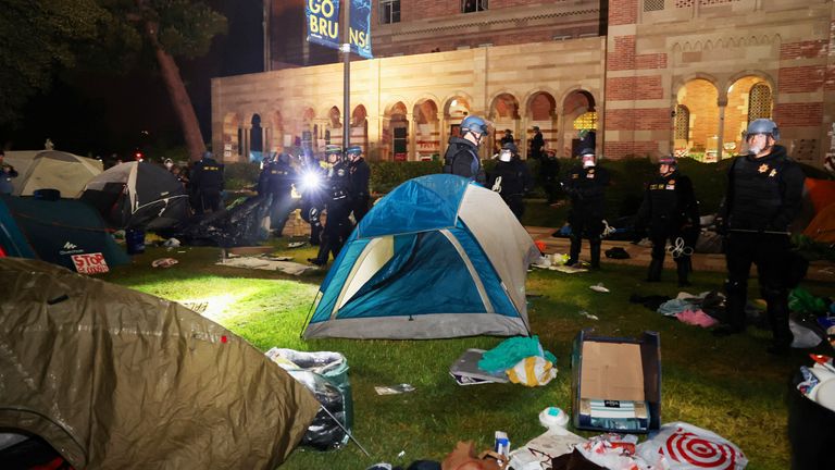 Law enforcement official moves a tent at the protest encampment in support of Palestinians at the University of California Los Angeles (UCLA), as the conflict between Israel and the Palestinian Islamist group Hamas continues, in Los Angeles, California, U.S., May 2, 2024. REUTERS/Aude Guerrucci