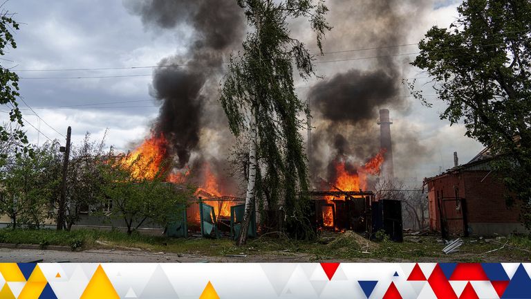 Residential houses on fire after Russian airstrikes in Vovchansk. Pic: AP