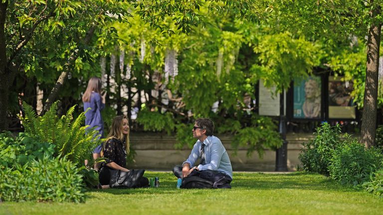 People relaxing in the warm weather near St Paul's Cathedral in London. Picture date: Thursday May 9, 2024.