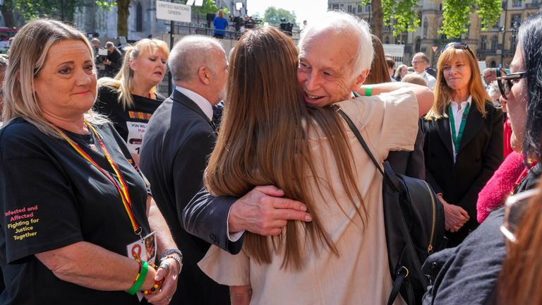 Chairman of the infected blood inquiry Sir Brian Langstaff with victims and campaigners outside Central Hall in Westminster.
Pic:PA