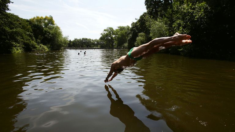 EMBARGOED TO 0001 MONDAY MAY 13 File photo dated 30/07/14 of a swimmer diving into the water at the mixed bathing ponds in Hampstead Heath, London. A record number of wild swimming spots have been designated as bathing sites in England ahead of the summer months, the Government has confirmed. The Environment Agency will immediately start monitoring the water quality at 27 sites which the Government had proposed as new bathing sites during a consultation earlier this year. Issue date: Monday May 