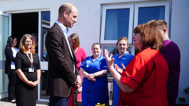 The Duke of Cornwall chats to staff at St Mary's Community Hospital. Pic: PA