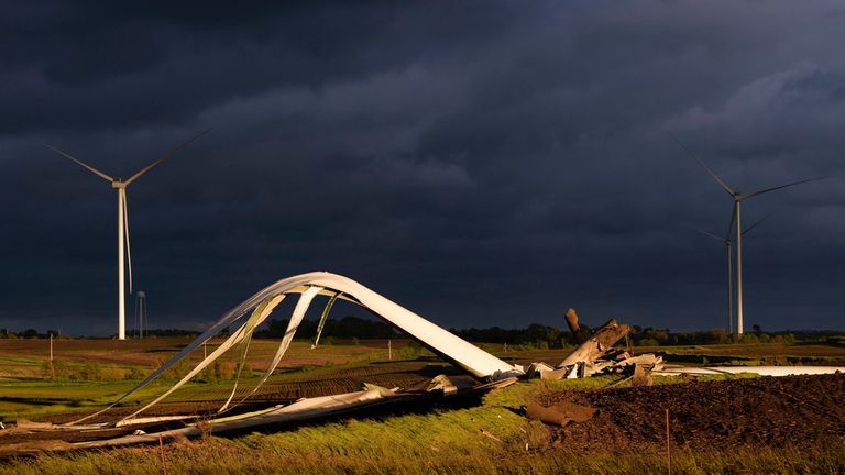 The remains of a wind turbine damaged by a tornado touch the ground in a field, Tuesday, May 21, 2024, near Prescott, Iowa.  (AP Photo/Charlie Neibergall)