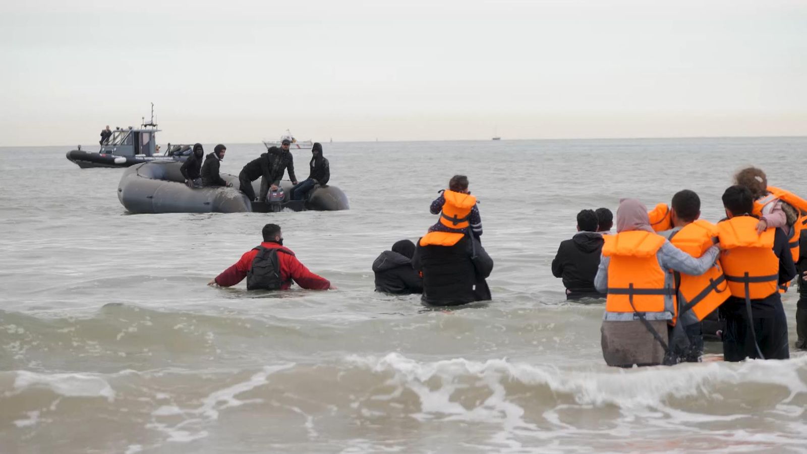 Migrants try to board small boat off French beach in desperate bid for Britain - as powerless police watch on