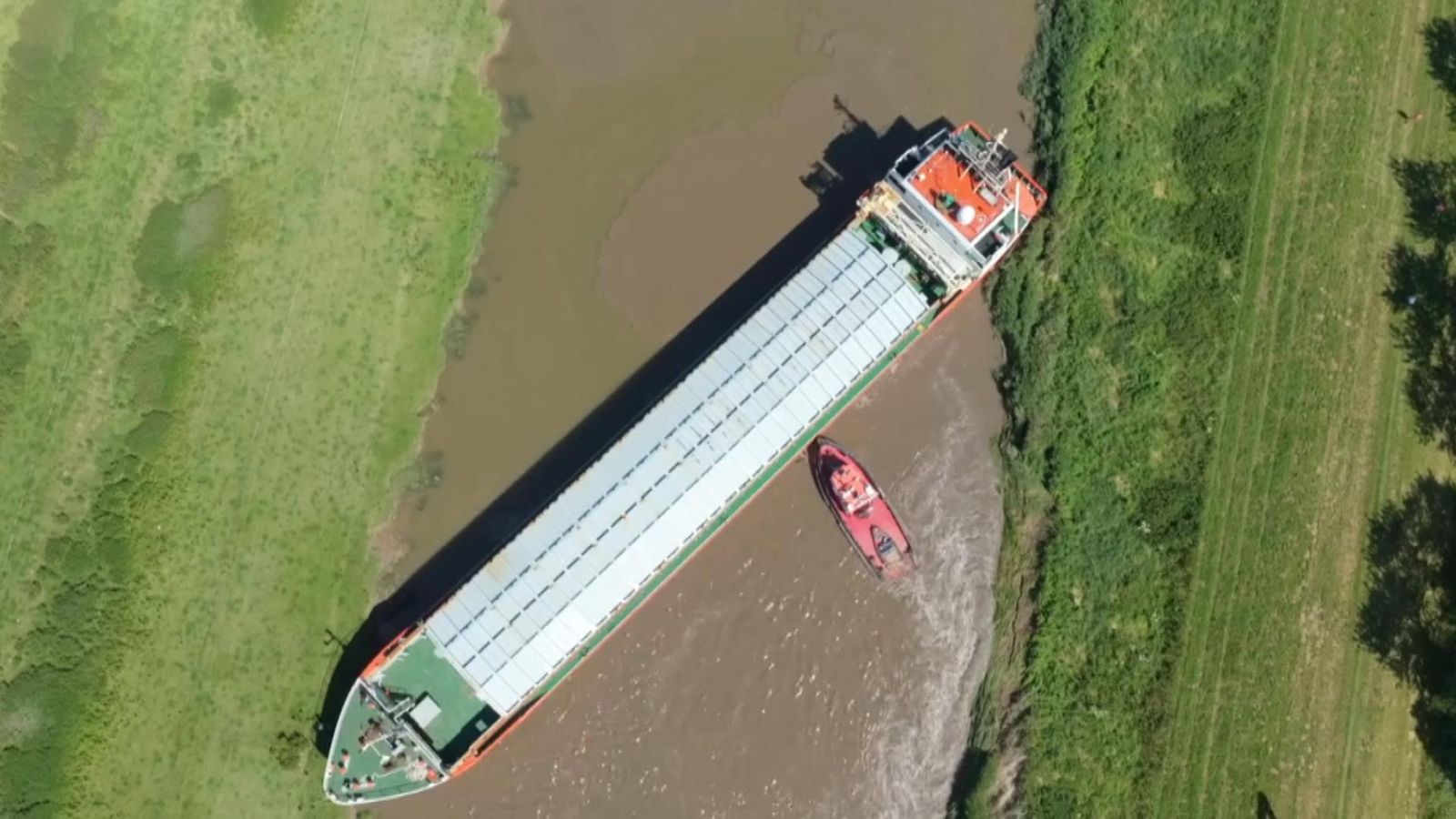 Watch footage of cargo ship stuck in river Nene while carrying timber ...