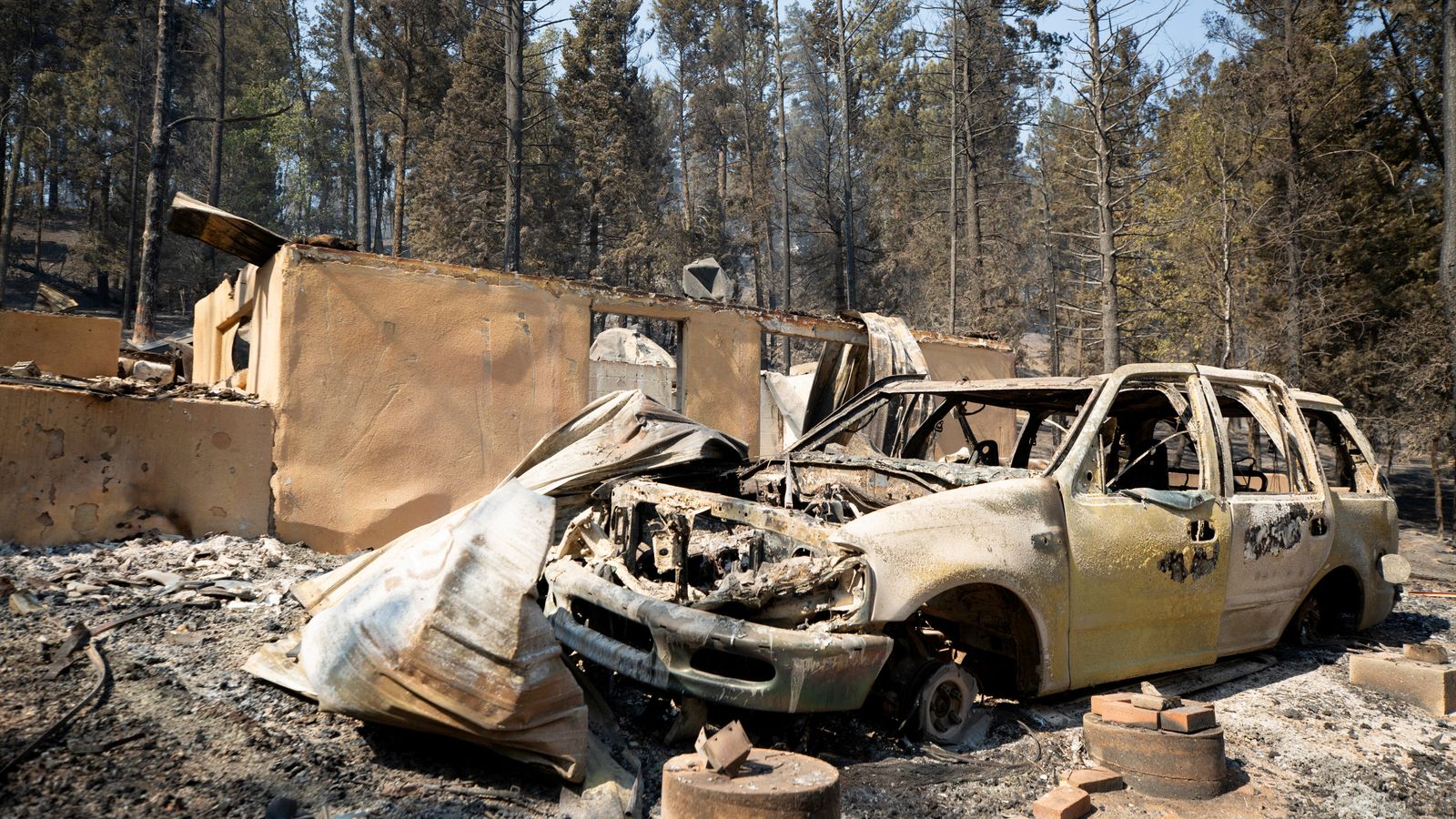 At least one dead in New Mexico village from wildfire that forced ...