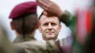 A soldier salutes French President Emmanuel Macron as he attends a ceremony to pay homage to the Saint Marcel maquis, a force of French Resistance fighters during World War II and the French SAS (Special Air Service) paratroopers. Pic: AP