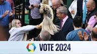 A person throws a drink in the face of  Nigel Farage.
Pic AFP/Getty Images