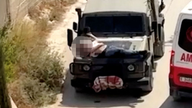 The Palestinian man strapped to the front of the car. Pic: Reuters