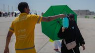 A pilgrim receives a cold water spray in Mina, near Mecca. Pic: AP