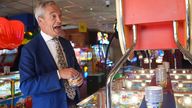 Reform UK leader Nigel Farage playing a 2p machine in Clacton-on-Sea, Essex, while on the General Election campaign trail. Picture date: Friday June 21, 2024.