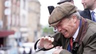 Reform UK leader Nigel Farage reacts after something is thrown towards him on the Reform UK campaign bus in Barnsley, South Yorkshire, whilst on the General Election campaign trail. Picture date: Tuesday June 11, 2024.
