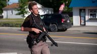 An officer with the Oakland County Sheriff's Department secures the scene of a shooting at the Brooklands Plaza Splash Pad, Saturday, June 15, 2024, in Rochester Hills, Mich. (Katy Kildee, The Detroit News/Detroit News via AP)