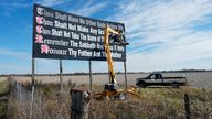FILE - Workers repaint a Ten Commandments billboard off of Interstate 71 on Election Day near Chenoweth, Ohio, Tuesday, Nov. 7, 2023. Louisiana has become the first state to require that the Ten Commandments be displayed in every public school classroom under a bill signed into law by Republican Gov. Jeff Landry on Wednesday. (AP Photo/Carolyn Kaster, File)