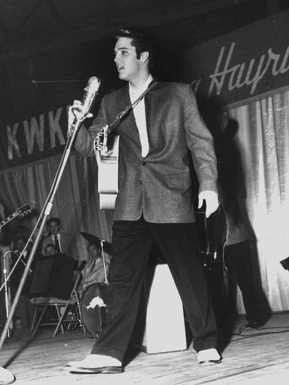 In this Dec. 15, 1956 photo, Rock-n-Roll legend Elvis Presley entertains a packed house as a headlining act during a special performance of the KWKH Louisiana Hayride at Hirsch Coliseum in Shreveport, La. The Hayride helped launch Presley's career. In fact, he held his first radio broadcast on Oct. 16, 1954 at the Louisiana Hayride in the Municipal Auditorium in Shreveport, La. The phrase "Elvis has left the building!" was coined by then Hayride manager Horace Logan the night this photo was take