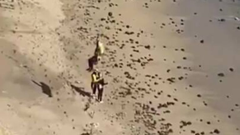 Stranded kite surfer rescued by helicopter after spelling out 'help'