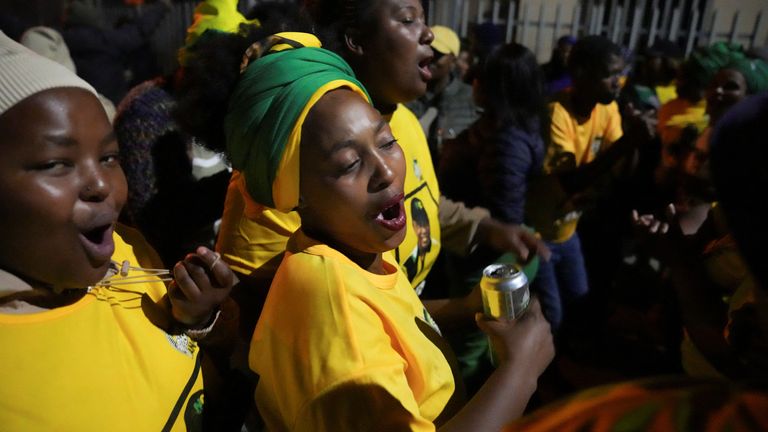 ANC supporters dance outside a polling station during the election. Pic: Reuters