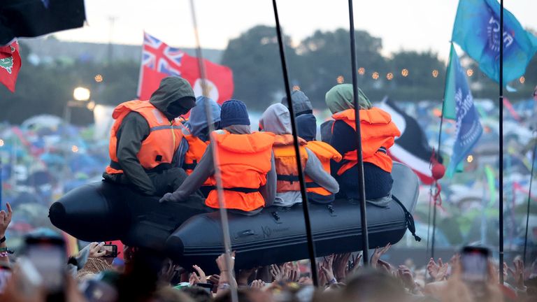 The migrant boat appeared above the crowd during Lil Simz's set.  Photo: AP / UK celebrity photos / Cover images