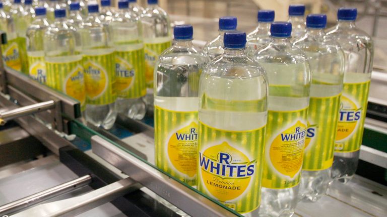 Bottles of R Whites lemonade, made by soft drinks company Britvic, sit on a conveyor belt at Britvic's bottling plant in London March 25, 2009. REUTERS/Luke MacGregor (BRITAIN BUSINESS)