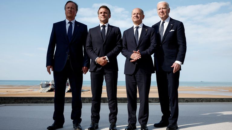 Lord Cameron (L) stood in for Mr Sunak for a photo with the French, German and US leaders. Pic: Reuters