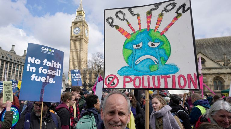 Activists protest outside the Houses of Parliament in London, Friday, April 21, 2023. Extinction Rebellion and other environmental groups are protesting for four days from Friday to Monday, with an event they are calling "The Big One". (AP Photo/Kin Cheung)