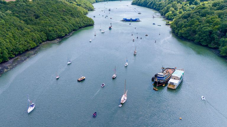 An 80-strong boat flotilla, one for each year since the D-Day landings, sails off the coast of Cornwall. Pic: PA 