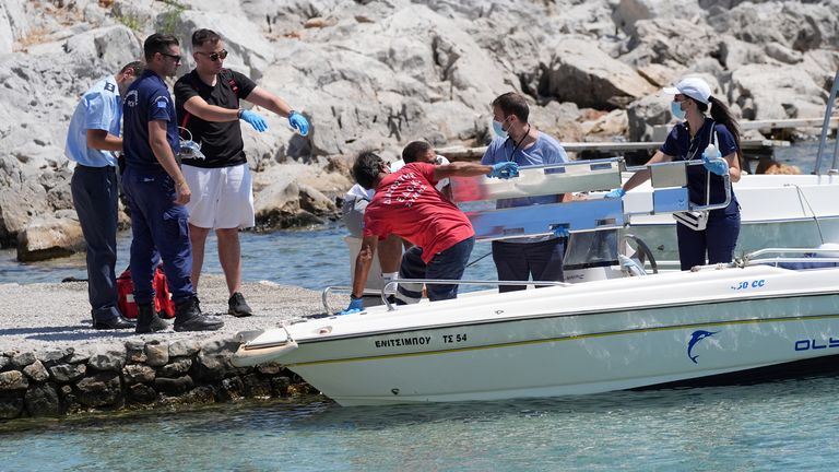 Pic: Yui Mok/PA
Emergency services lifting an empty stretcher off a boat at Agia Marina in Symi, Greece, where a body has been discovered