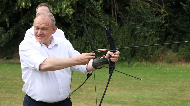 Sir Ed Davey tries his hand at archery in Little Paxton, Cambridgeshire. Pic: PA