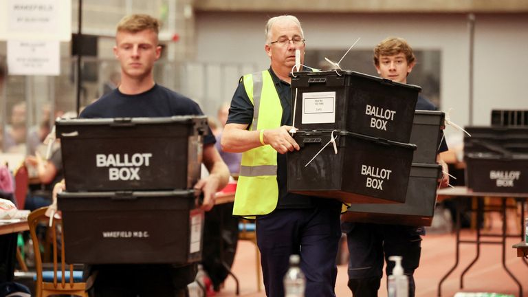 Staff carry ballot boxes at a counting centre in Thornes Park Stadium after a by-election in Wakefield, Britain, June 23, 2022. REUTERS/Phil Noble