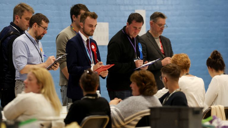 Election observers watch as staff count ballot papers for the Tiverton and Honiton by-election, at Lords Meadow Leisure Centre in Devon, Britain, June 23, 2022. REUTERS/Paul Childs