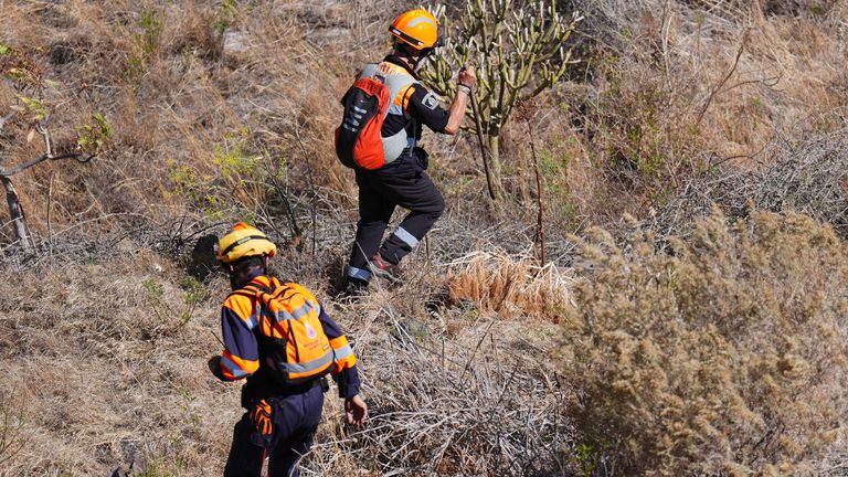 Emergency workers near the village of Masca, Tenerife.
Pic: PA