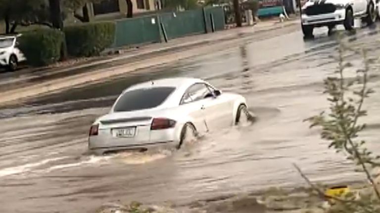 Car pushes through heavy flooding in US