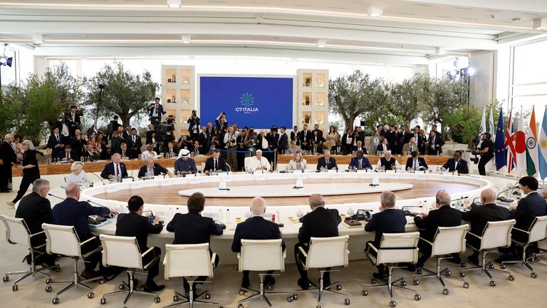 Pope Francis, G7 leaders and guests attend a session during the G7 Summit.
Pic: Reuters